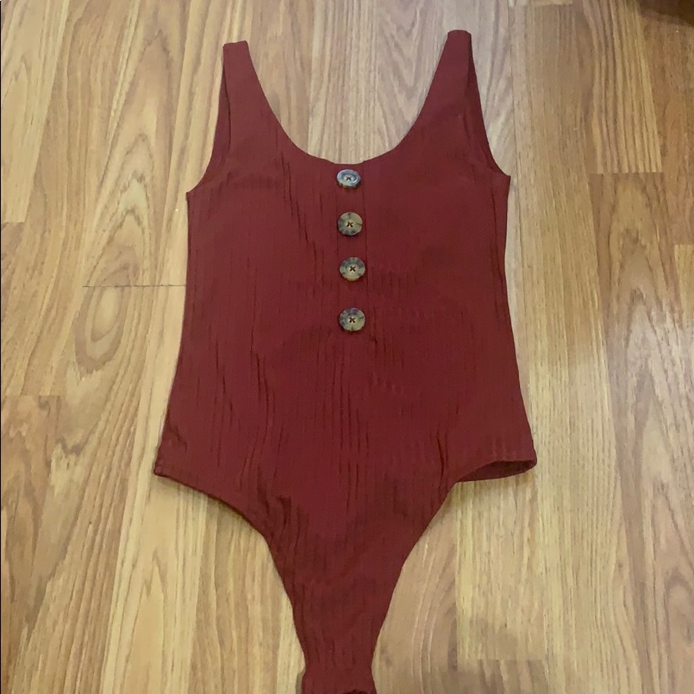 A red button down body suit that is never worn :)